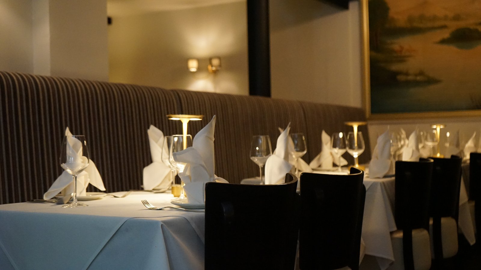 Dining chairs set at a table at Voujon